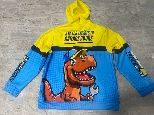 Yellow and blue hoodie with a dinosaur graphic and text on a gray surface