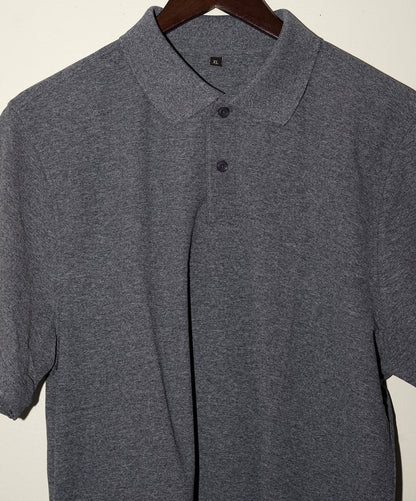 Gray navy blue polo shirt on a hanger against a plain background
