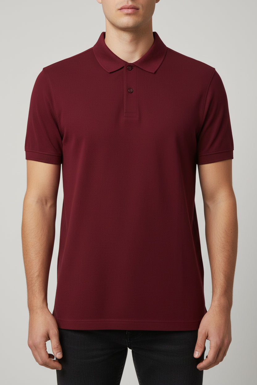 Maroon polo shirt on a hanger against a beige background