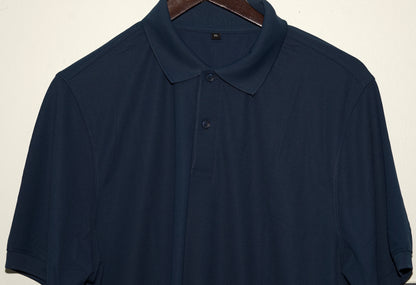 Navy blue polo shirt on a hanger against a beige background