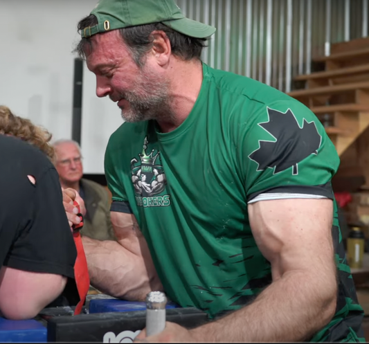 Man wearing a green jersey t-shirt with a black maple leaf