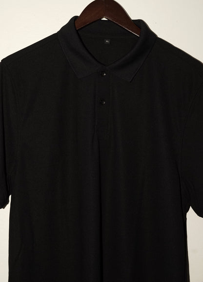 Black polo shirt on a wooden hanger against a plain background