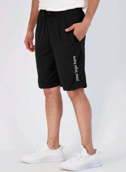 Person wearing black shorts and white sneakers on a light gray background