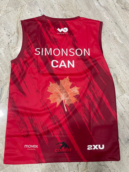 Red sports jersey with a maple leaf and branding on a light gray surface