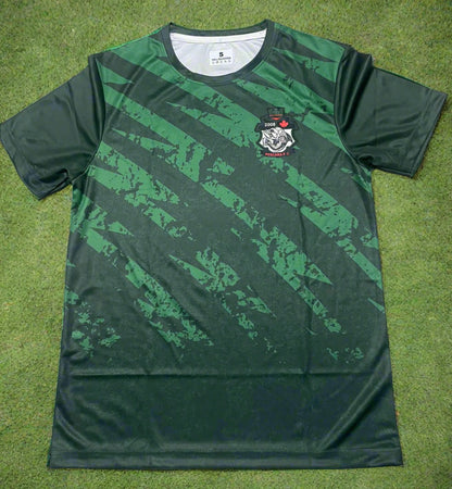 Green sports jersey with a logo on a light brown surface
